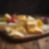 Different types of sliced cheese arranged on a wooden board