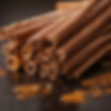 A close-up view of cinnamon candy oil droplets with cinnamon sticks.