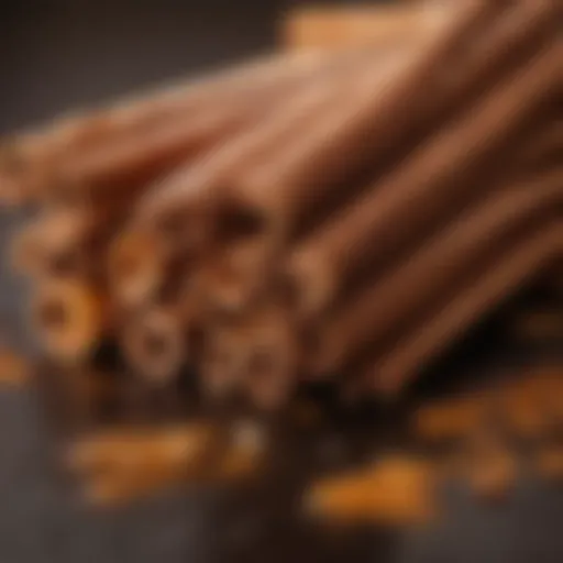 A close-up view of cinnamon candy oil droplets with cinnamon sticks.