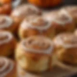 A close-up of freshly baked cinnamon pumpkin rolls showcasing their gooey texture and vibrant color.