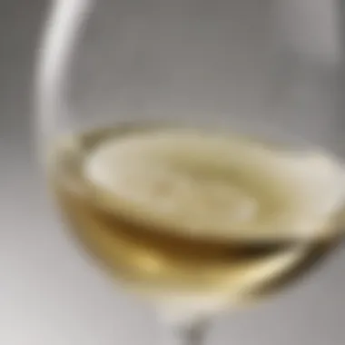 Close-up of a glass of white wine reflecting light