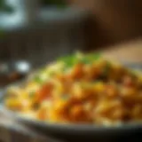 A rich and creamy plate of cheesy shredded potatoes garnished with fresh herbs