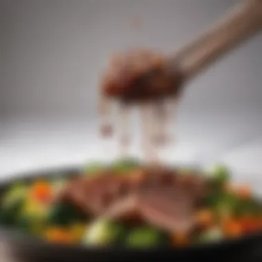 A vibrant teriyaki sauce being drizzled over grilled meats and vegetables.