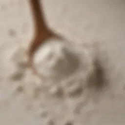 A close-up view of self-raising flour with a spoon, showcasing its texture
