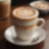 A close-up view of a beautifully crafted Café Latte with intricate latte art on top.