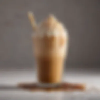 A close-up view of an iced brown sugar oatmilk shaken espresso with a frothy top and caramel drizzle.