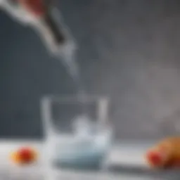 Close-up of an immersion blender crushing ice in a tall glass