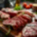 Various cuts of steak displayed on a wooden board