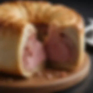 A close-up view of a pork pie cut in half, revealing its savory filling and texture