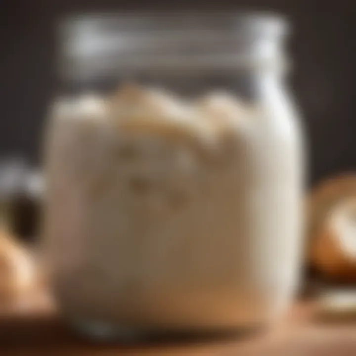 A close-up of a bubbling sourdough starter in a glass jar