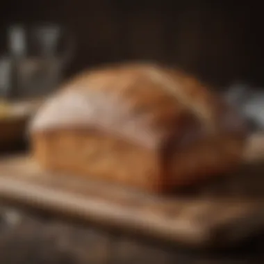 A beautifully scored loaf of sourdough bread on a wooden board