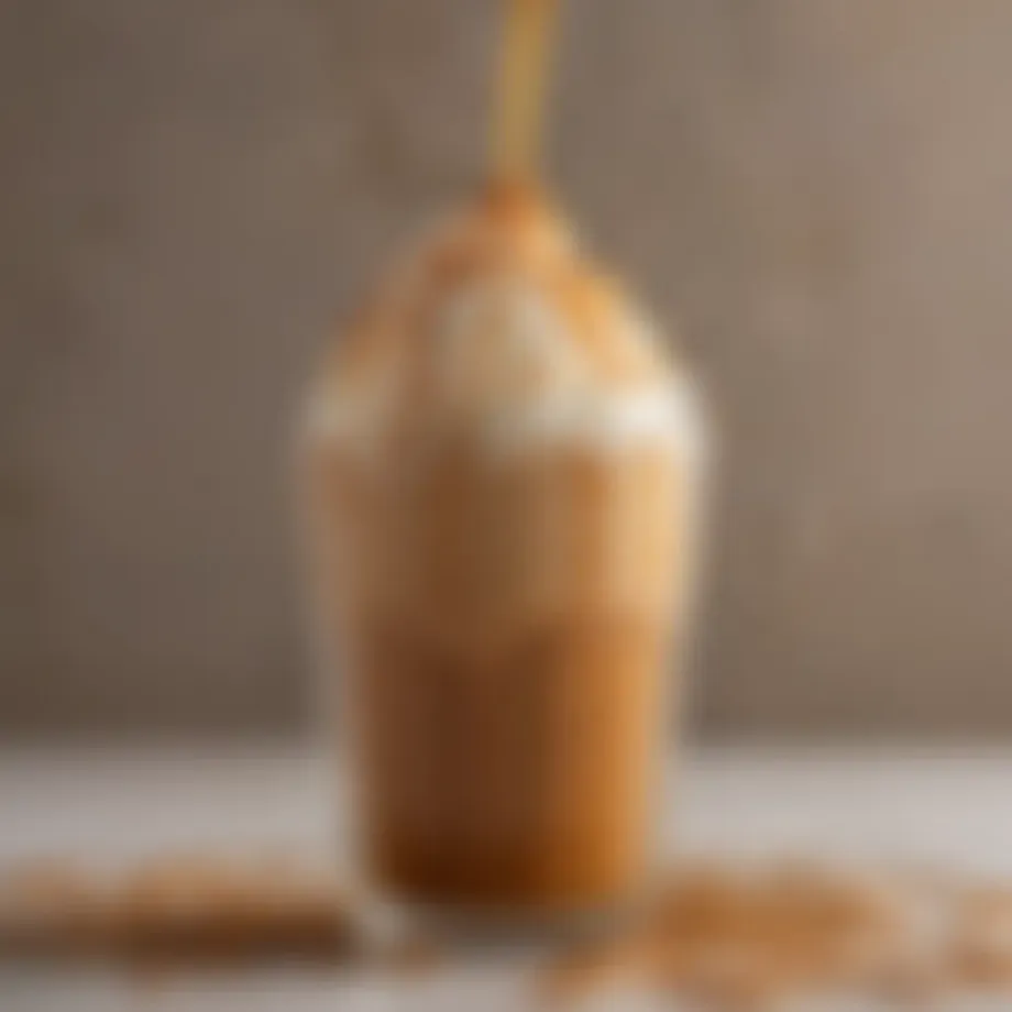 Close-up of caramel drizzled over a frappuccino in a glass