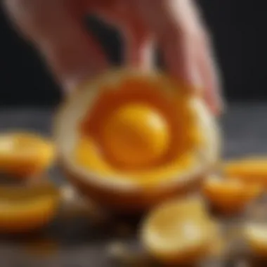 Close-up of egg yolk breaking open to reveal its rich color