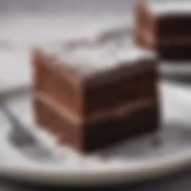 Beautifully Plated Flourless Chocolate Cake Slice A beautifully plated slice of flourless chocolate cake with a dusting of powdered sugar.