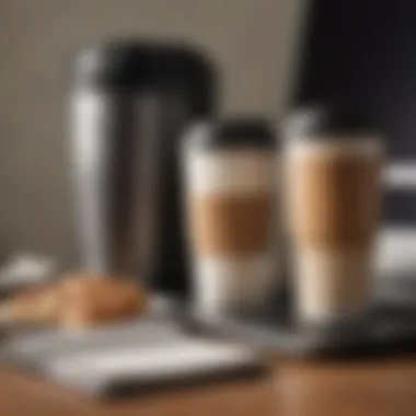A thermal travel mug next to a laptop, illustrating the convenience for on-the-go professionals